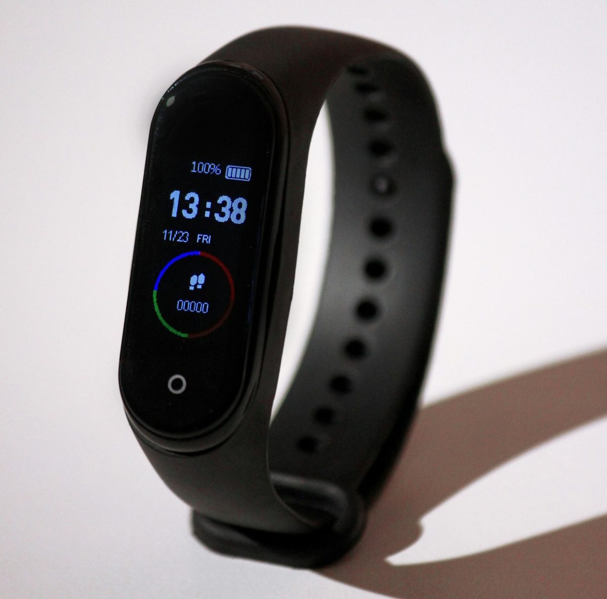 Black touchscreen smartwatch band showing time and step count