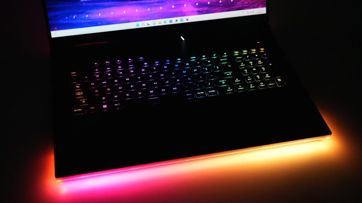 Gaming laptop with rainbow RGB backlit keyboard and orange underglow