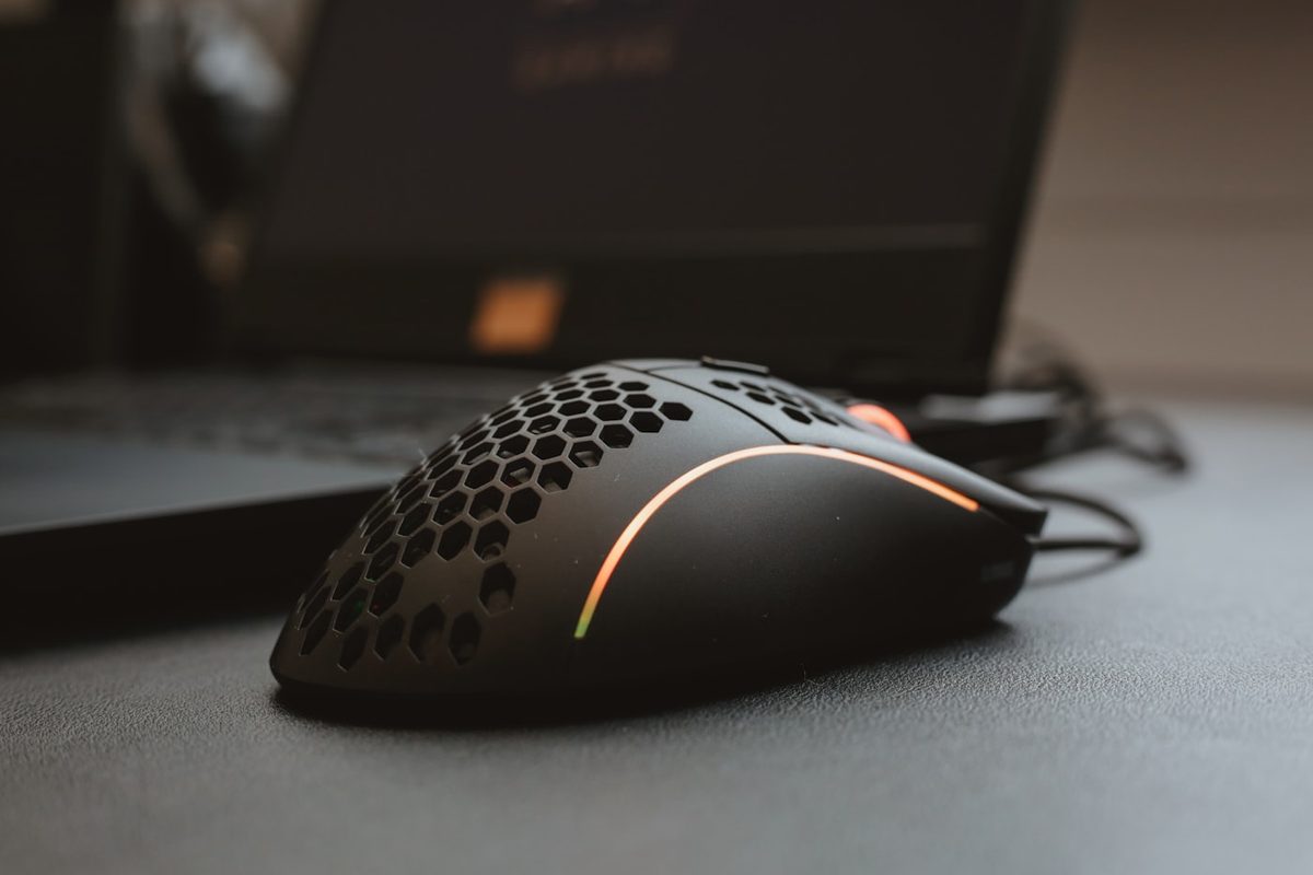 Black honeycomb-shell lightweight gaming mouse with an RGB accent stripe