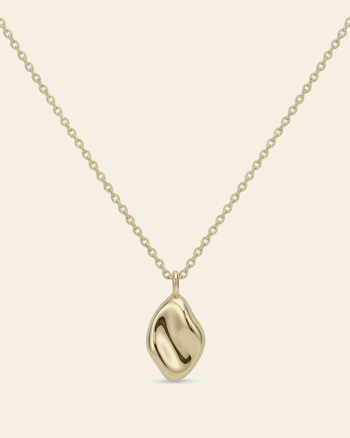 Gold necklace with a rounded wave-form pendant