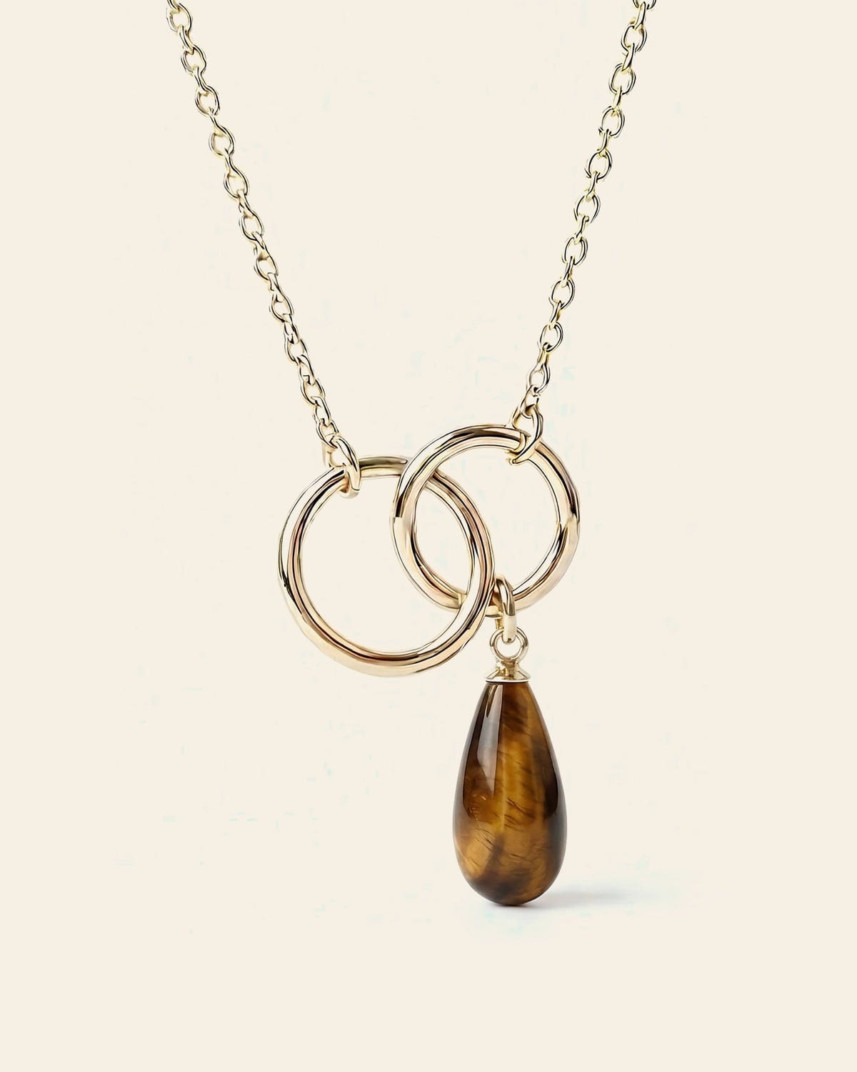 Gold necklace with a tiger's eye stone pendant